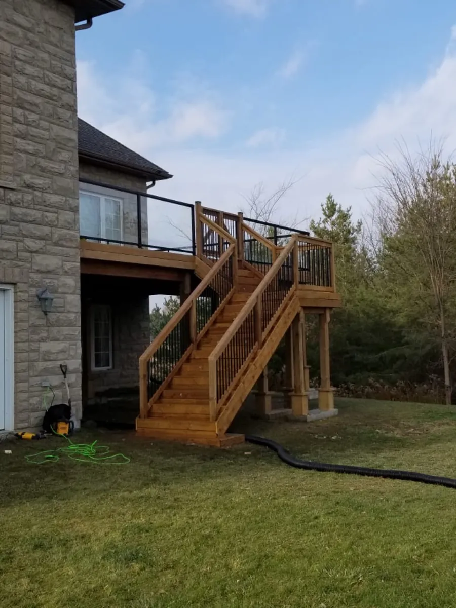 Recent Northern Deck project: tall two-story pressure-treated deck with a long staircase
