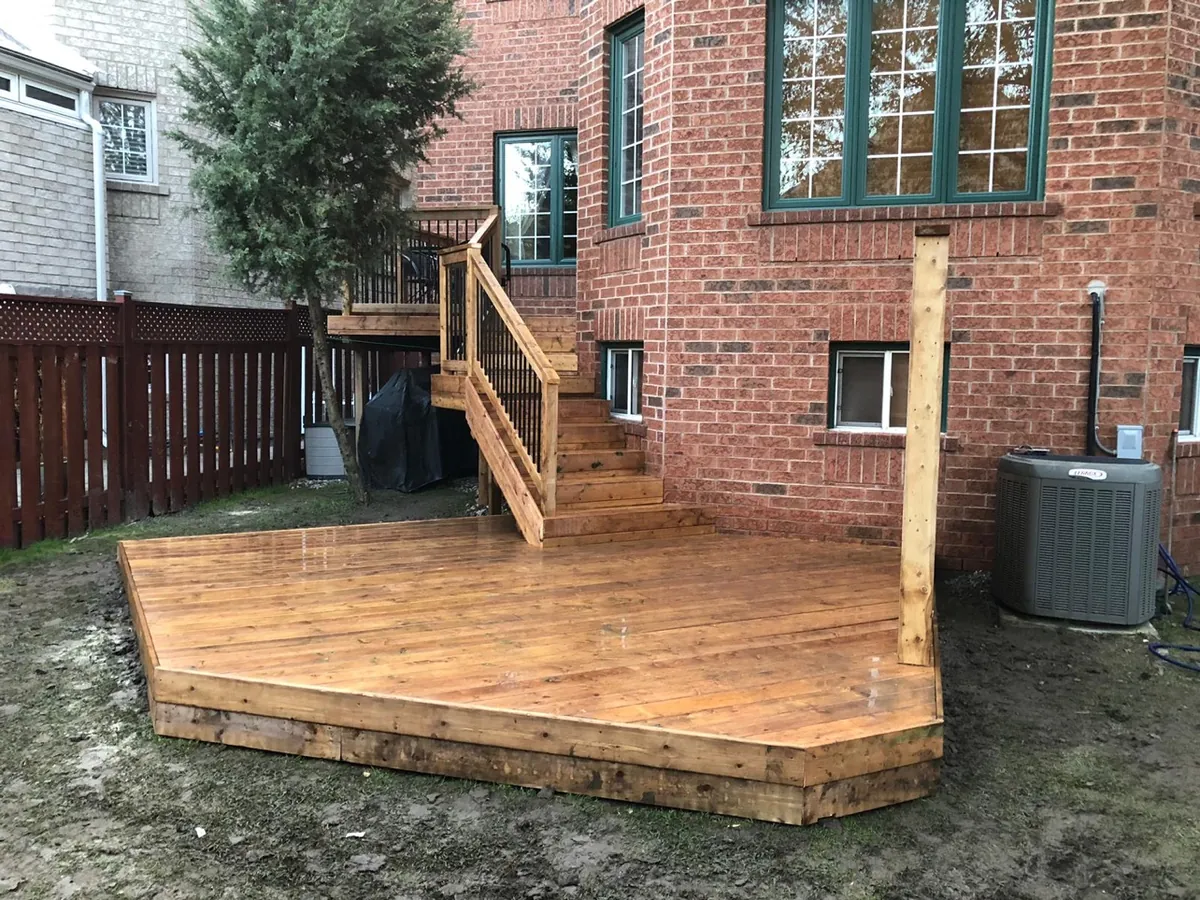 Recent Northern Deck project: pressure-treated deck stairs with wood rails and black metal spindles