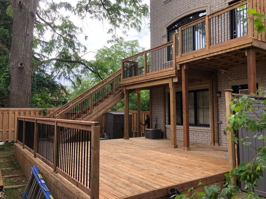 Recent Northern Deck project: two-tier pressure-treated deck with black metal railings and stairs